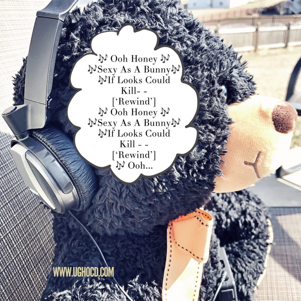 Black teddy bear with headphones and a song