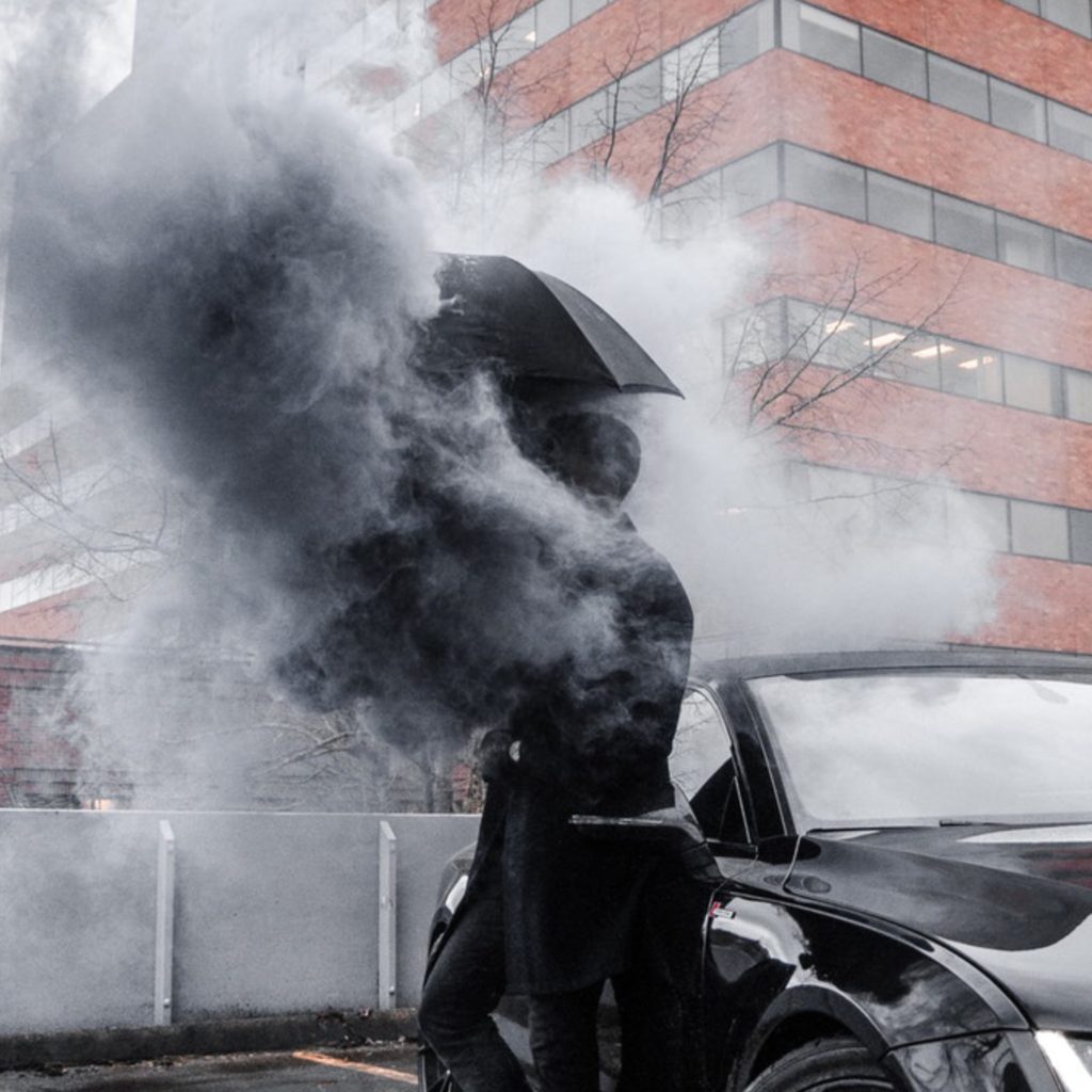 Magical thinking guy under umbrella with poof smoke